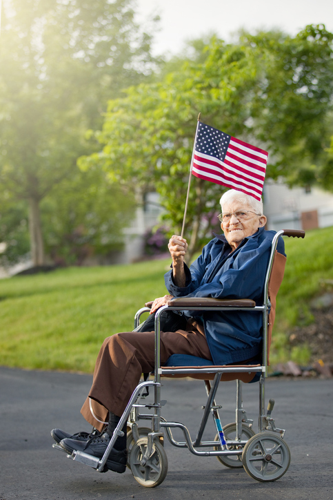 An elderly veteran waving an American flag